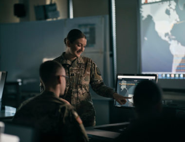 solider in front of computer instructing soilder