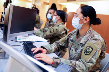 solider on computer with mask