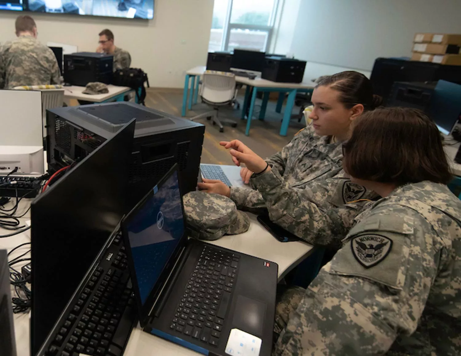 soldiers reviewing information about cybersecurity